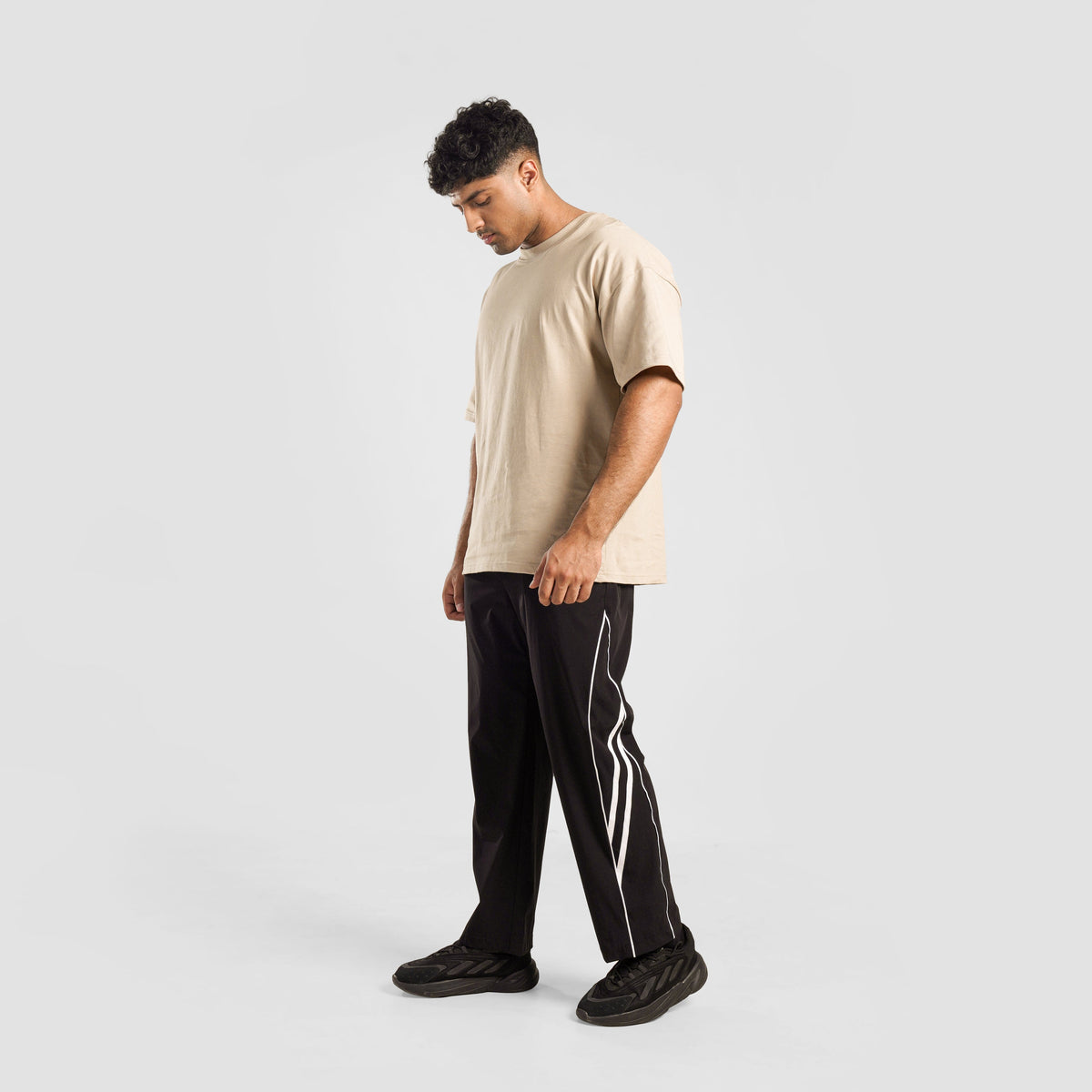 Full-length view of Black Dual Stripe Trousers 2.0 for men