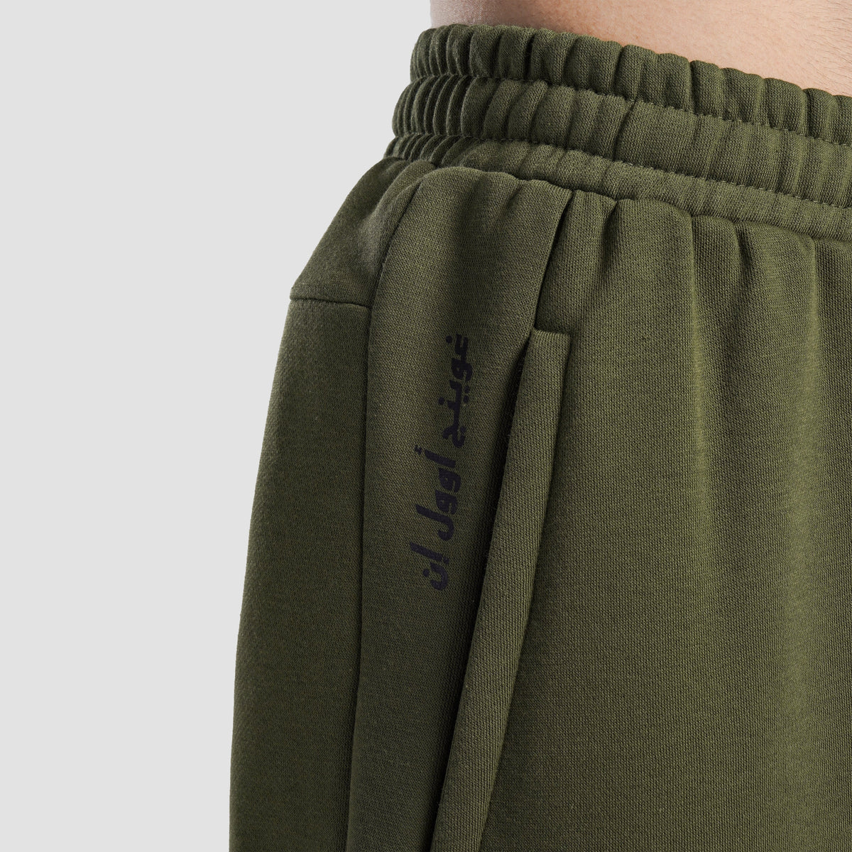 Close-up stitching detail on Olive Axis Strike Trouser for men